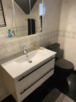 a bathroom with a white sink and a toilet at Leilighet med sydvendt balkong in Ålesund