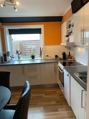 a kitchen with a sink and a window at Leilighet med sydvendt balkong in Ålesund