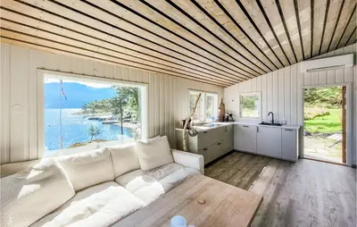 a living room with a white couch and a large window at Amazing Home In Tørvikbygd With Wifi in Tyrvikbygd