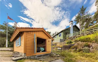 a tiny house with a door open in front of a house at Amazing Home In Tørvikbygd With Wifi in Tyrvikbygd