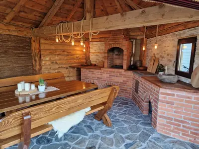 a dining room with a table and a brick fireplace at Mountain & Fjord View Apartment in Stryn