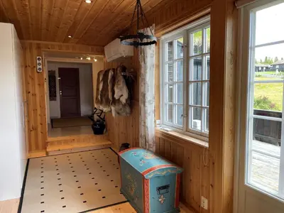 a room with a trunk in a room with windows at Snikkerplassen - cabin with amazing view and hiking opportunities in Sør-Fron