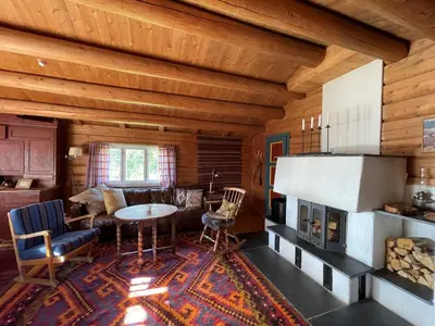 a living room with a fireplace in a log cabin at Elveseter - log cabin with an amazing view in Venabygd