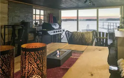 a dining room with a table and a view of the water at Stunning Home In Fitjar With Wifi in Fitjar