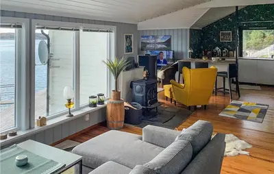 a living room with a couch and a table at Stunning Home In Fitjar With Wifi in Fitjar