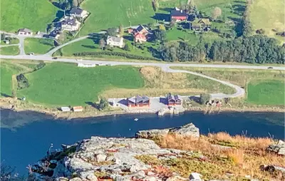 an aerial view of a house on a hill next to a river at 2 Bedroom Cozy Home In Straumgjerde in Riksem