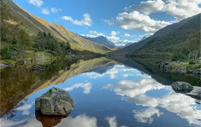 a reflection of the sky in a river in a valley at 2 Bedroom Cozy Home In Straumgjerde in Riksem