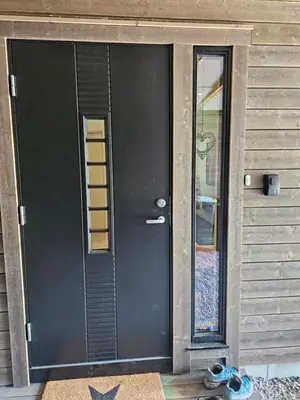 a black door of a house with a pair of shoes at Panorama view in Stranda
