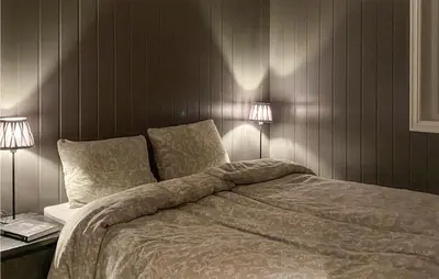 a bedroom with a bed with two lamps on it at Nice Home In Rauland With House A Mountain View in Rauland