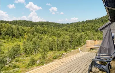 a bench sitting on a deck with a view of a forest at Nice Home In Rauland With House A Mountain View in Rauland