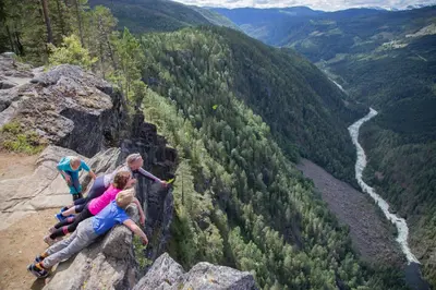 a group of people sitting on top of a mountain at Groven Camping & Hyttegrend in Åmot