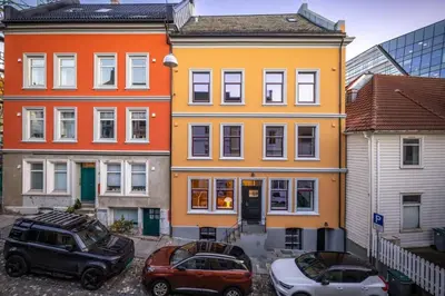 a group of buildings with cars parked in front of them at Dinbnb Apartments I New 2023 I 600m to Bryggen in Bergen