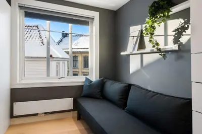 a living room with a couch and a window at Dinbnb Homes I Historical 1850 House in Bergen