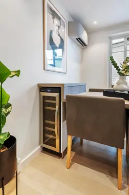 a dining room with a table and a cabinet at Dinbnb Homes I Historical 1850 House in Bergen