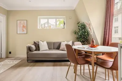 a living room with a couch and a table at Dinbnb Apartments I New 2021 I SONOS and SMART TV in Bergen