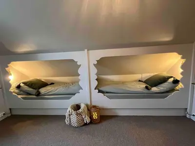 a bedroom with two beds with pillows on them at Nakkentunet - familievennlig hus på gårdstun. in Ørskog