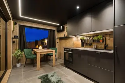 a kitchen with a table and a dining room at Hide Hut - Amazing view 50 min from Oslo in Stange