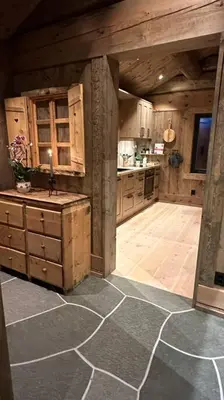 a large kitchen with wooden cabinets and a counter at Liaplassen Mountain Chalet - Beitostølen in Beitostøl