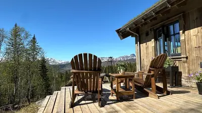 two chairs and a table on a wooden deck at Liaplassen Mountain Chalet - Beitostølen in Beitostøl