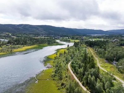 an aerial view of a river with trees at Spacious and modern apartment in the heart of Geilo, perfect year round! in Geilo