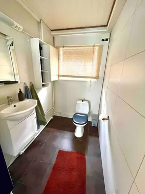 a small bathroom with a toilet and a sink at Apartment-A near Etne-Odda in Etnesjøen
