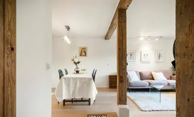 a living room with a table and a couch at The old bakery in Sandviken in Bergen