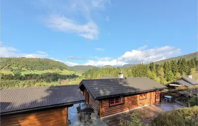 a log cabin with a view of the mountains at 3 Bedroom Stunning Home In Vossestrand in Vossestrand