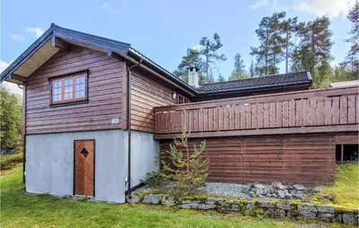 a wooden house with a fence on the side of it at 3 Bedroom Stunning Home In Vossestrand in Vossestrand