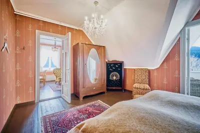 a bedroom with a bed and a chandelier at Visnes Hotel Stryn in Stryn