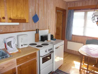 a kitchen with a white stove top oven next to a counter at Åsgardane Gjestegard in Gol