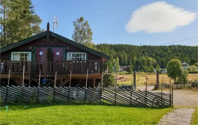 a log cabin with a fence in front of it at Lovely Apartment In Trysil With Wifi in Trysil
