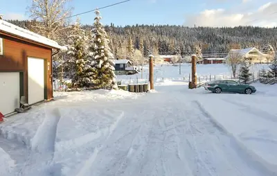 a car parked in the snow next to a house at Lovely Apartment In Trysil With Wifi in Trysil