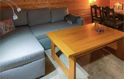 a living room with a couch and a wooden table at Lovely Apartment In Trysil With Wifi in Trysil