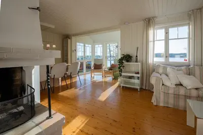 a living room with a couch and a fireplace at Skomakerhuset in Løten