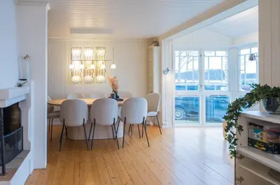 a kitchen and dining room with a table and chairs at Skomakerhuset in Løten