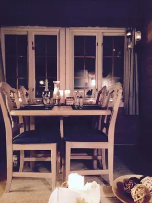 a dining room table with chairs and a table and a table and chairsktop at Osetunet, small and charming cabin at Ustaoset in Ustaoset