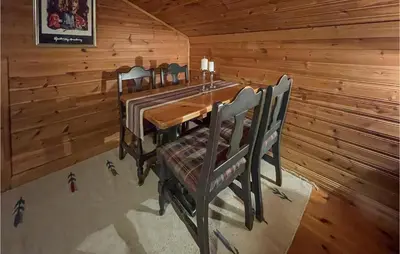 a dining room with a table and chairs in a cabin at 1 Bedroom Amazing Apartment In Trysil in Trysil