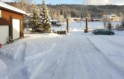 a car parked in the snow next to a house at 1 Bedroom Amazing Apartment In Trysil in Trysil