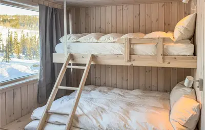 two bunk beds in a room with a window at 3 Bedroom Amazing Home In Tuddal in Tuddal