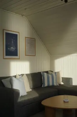 a living room with a couch and a table at Waterfront Rorbu - By the Beach in Bud