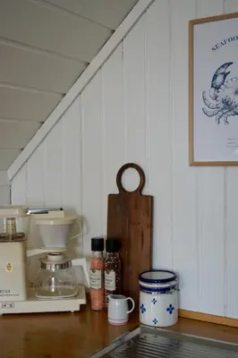 a kitchen counter with a mixer and other items on it at Waterfront Rorbu - By the Beach in Bud