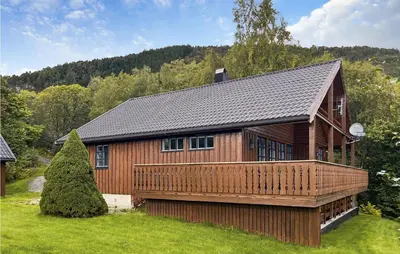 a large wooden house with a large deck at 4 Bedroom Nice Home In Midsund in Midsund