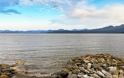 a pile of rocks on the shore of a body of water at 4 Bedroom Nice Home In Midsund in Midsund