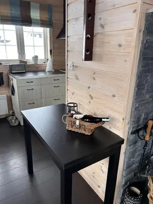 a black table with a basket on it in a kitchen at Saballie - Cosy cabin - sunny location! in Slåtto
