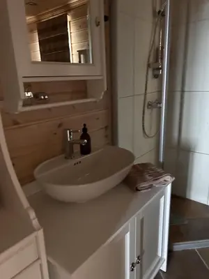 a bathroom with a sink and a shower at Saballie - Cosy cabin - sunny location! in Slåtto