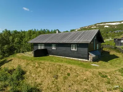 a small house on top of a hill at Saballie - Cosy cabin - sunny location! in Slåtto