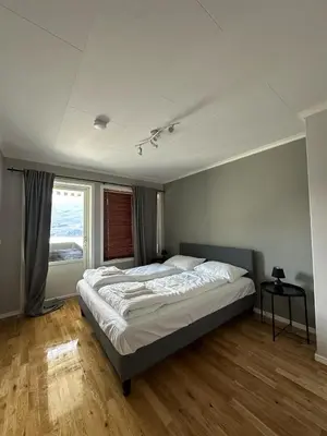 a bedroom with a large bed and a window at Leilighet med fantastisk utsikt in Stryn