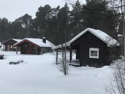 a couple of buildings with snow on the roofs at Båtstø Camping in Elga