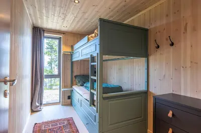 a bedroom with bunk beds in a tiny house at Unique new cabin by Hafjell & Skei with stunning view in Tretten