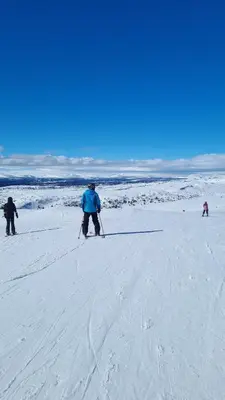 a group of people on skis in the snow at Unique new cabin by Hafjell & Skei with stunning view in Tretten